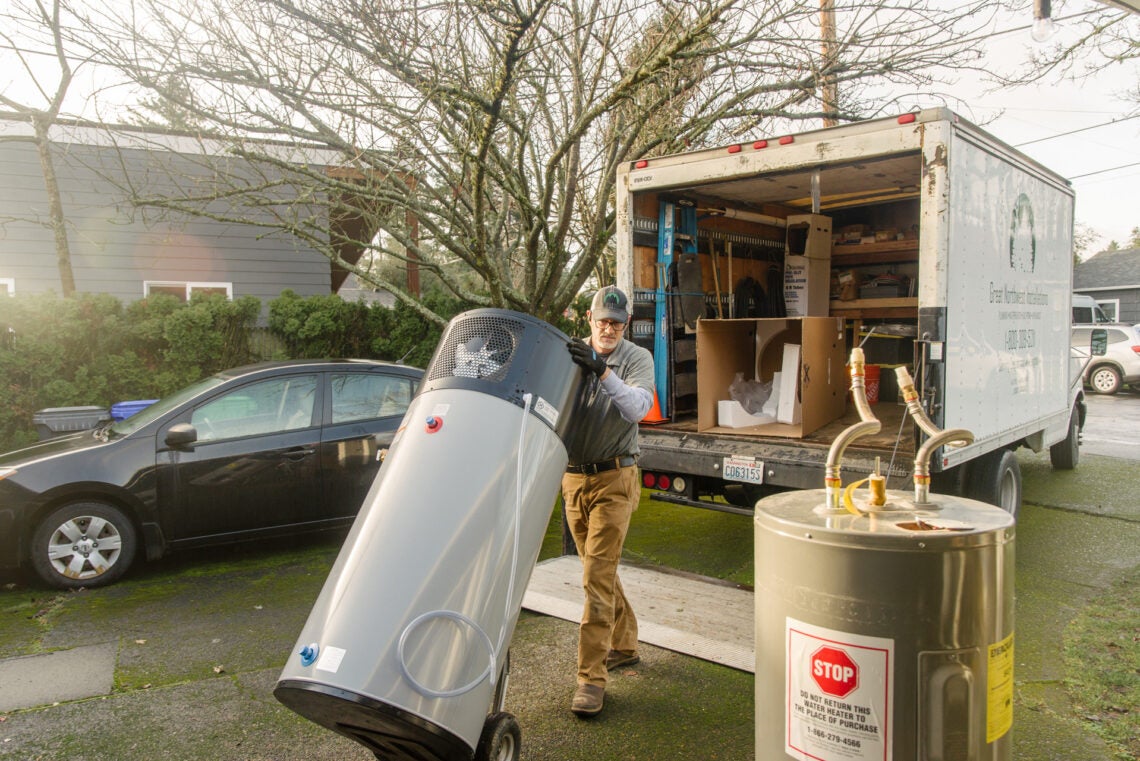 Installer wheeling a HPWH off the truck